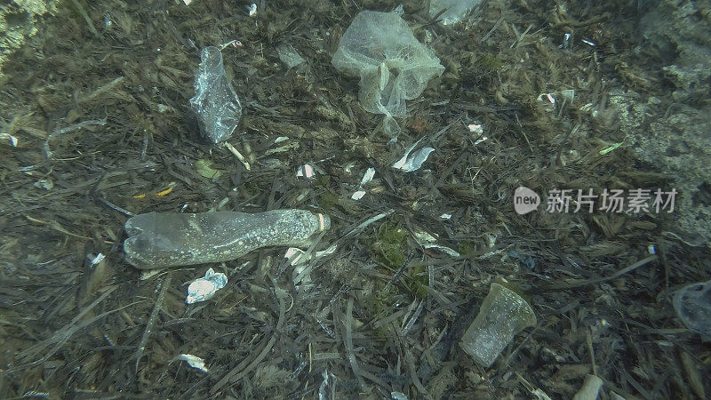 Massive plastic pollution of the ocean bottom. Seabed covered with a lot of plastic garbage. Bottles, bags and other plastic debris on seabed in Mediterranean Sea. Plastic pollution of the Ocean